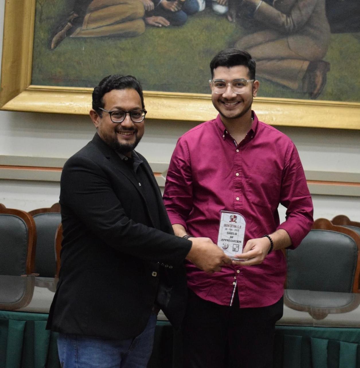 Raza Haider receiving a shield of appreciation for Orientation 5.0